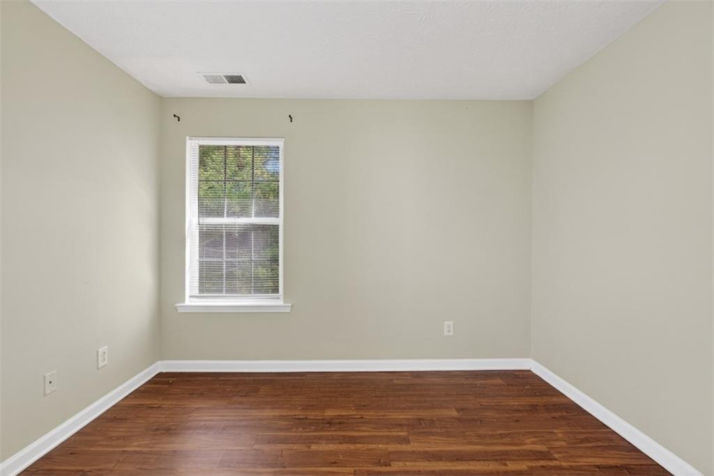 3159 Panthers Trace Decatur, GA 30034 - Photo 24 of 39 an empty room with wooden floor and windows