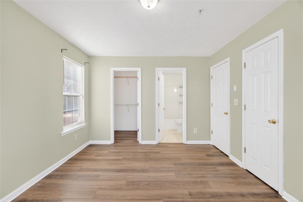 3159 Panthers Trace Decatur, GA 30034 - Photo 32 of 39 a view of an empty room with window and wooden floor