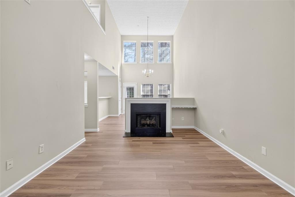 3159 Panthers Trace Decatur, GA 30034 - Photo 7 of 39 a view of an empty room with wooden floor fireplace and a window
