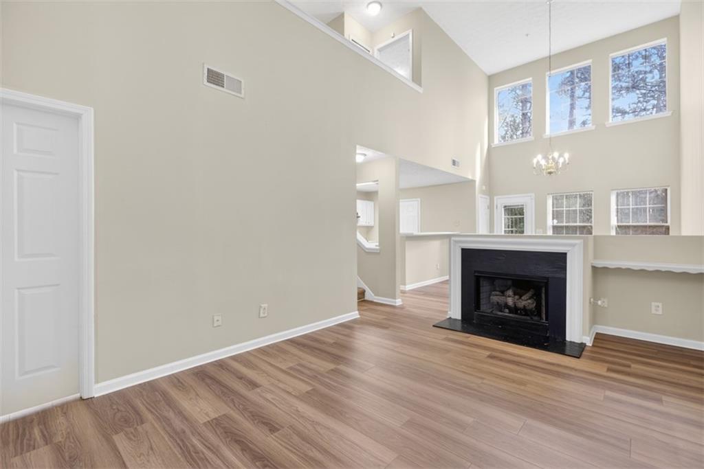 3159 Panthers Trace Decatur, GA 30034 - Photo 8 of 39 a view of an empty room with wooden floor fireplace and a window