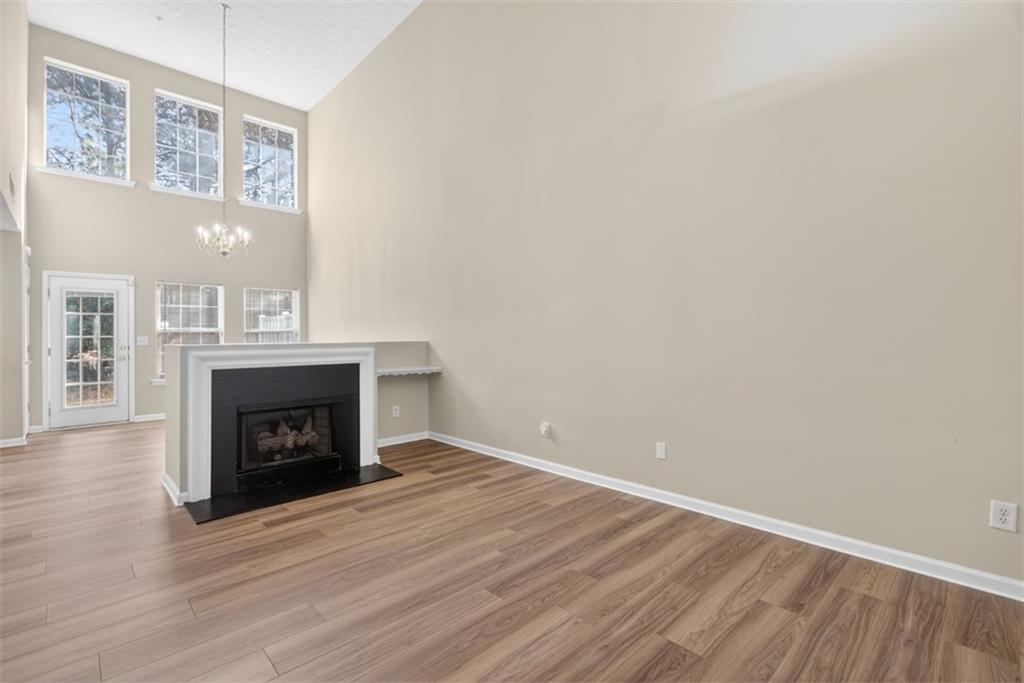 3159 Panthers Trace Decatur, GA 30034 - Photo 9 of 39 a view of an empty room with wooden floor and a fireplace