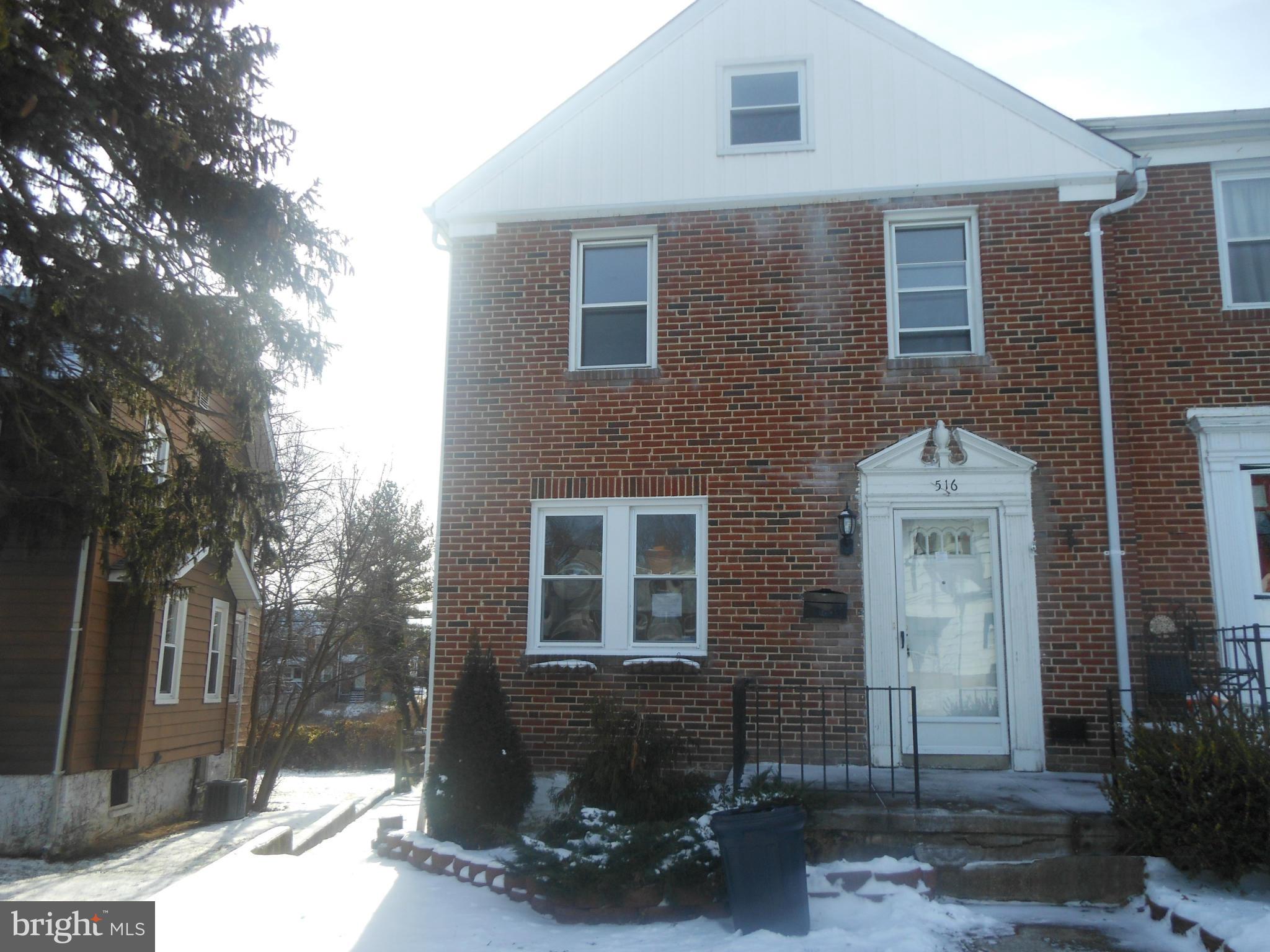 516 Charing Cross Road Baltimore, MD 21229 - Photo 1 of 9 a front view of a house with a yard