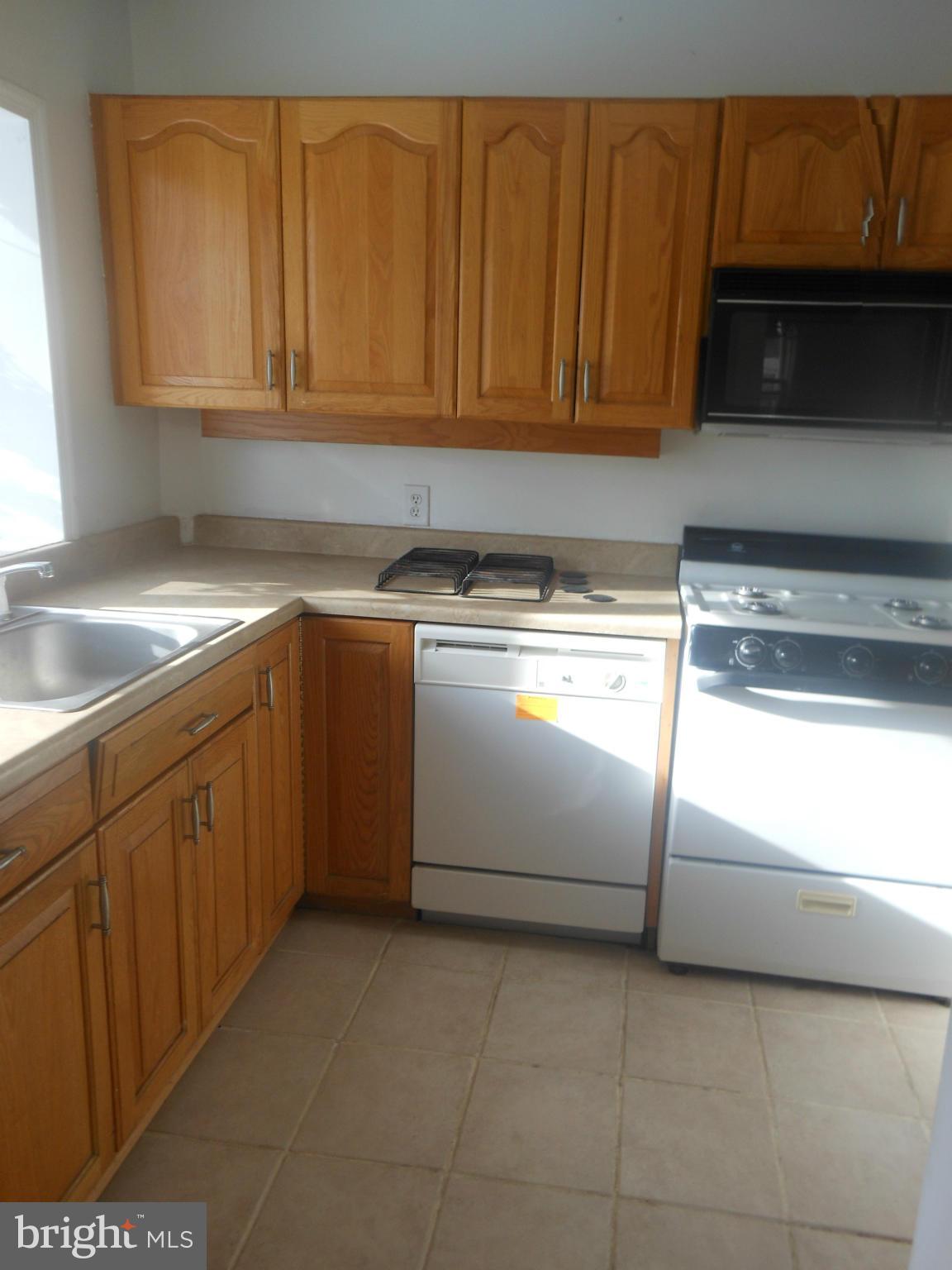 516 Charing Cross Road Baltimore, MD 21229 - Photo 6 of 9 a kitchen with granite countertop a sink and a stove