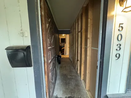 a view of a hallway with a furniture and closet