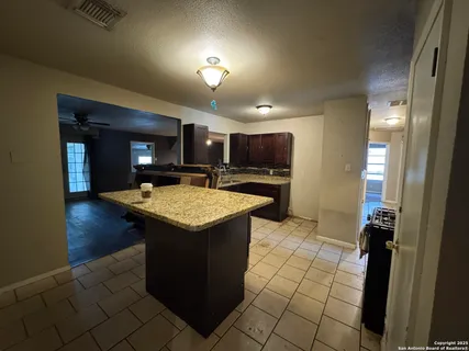 an outdoor space with wooden floor and a sink