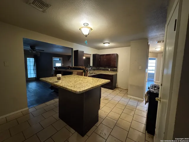 an outdoor space with wooden floor and a sink