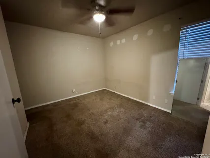 an empty room with a empty space and a ceiling fan