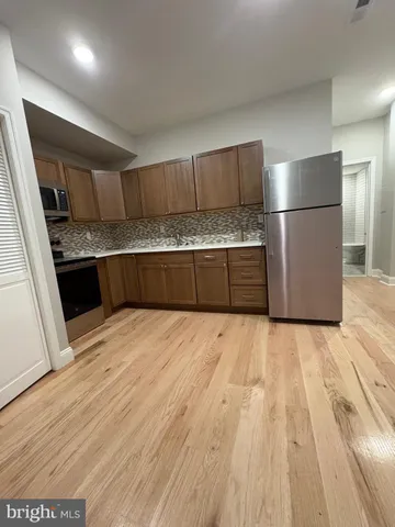 a kitchen with a refrigerator and a sink