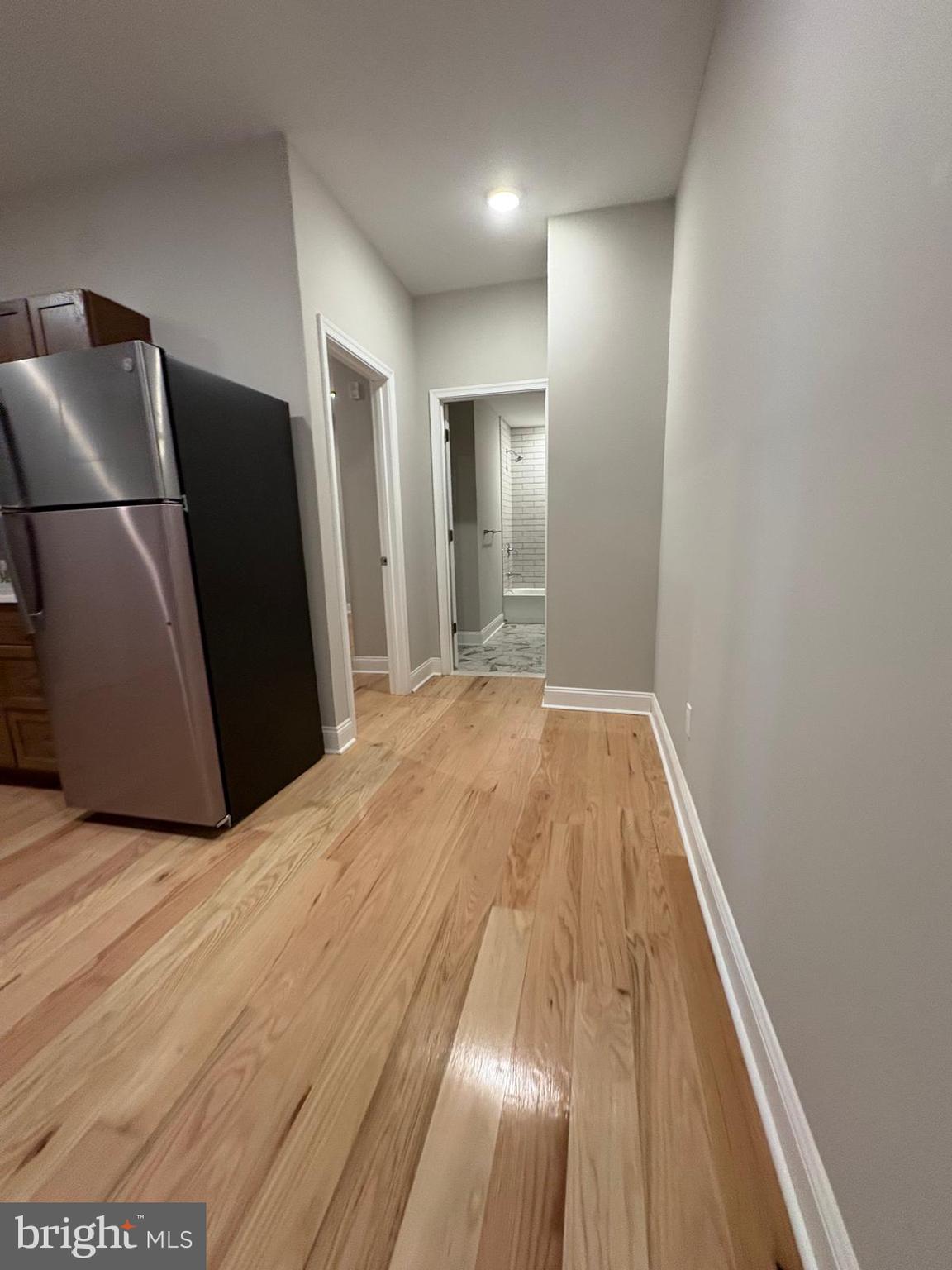 2900 North 5th Street, Unit 1 Philadelphia, PA 19133 - Photo 6 of 9 a view of a livingroom with wooden floor and a refrigerator