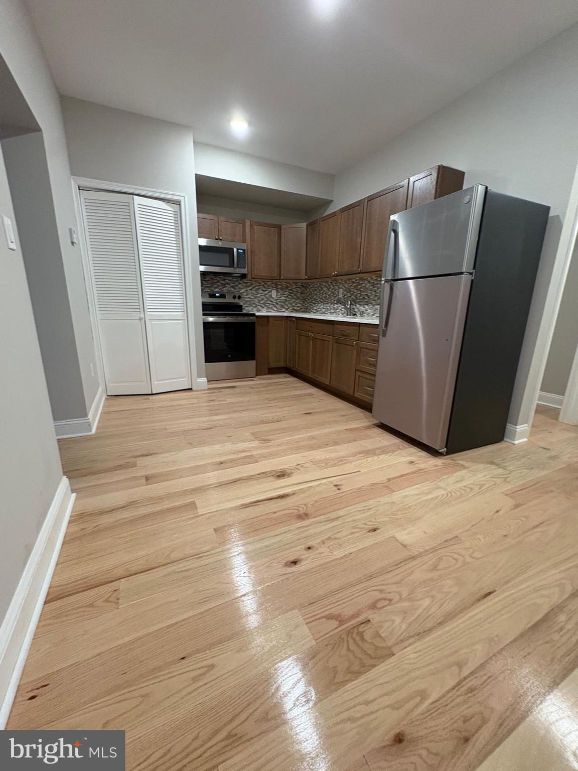 2900 North 5th Street, Unit 1 Philadelphia, PA 19133 - Photo 8 of 9 a kitchen with stainless steel appliances granite countertop a refrigerator and a sink