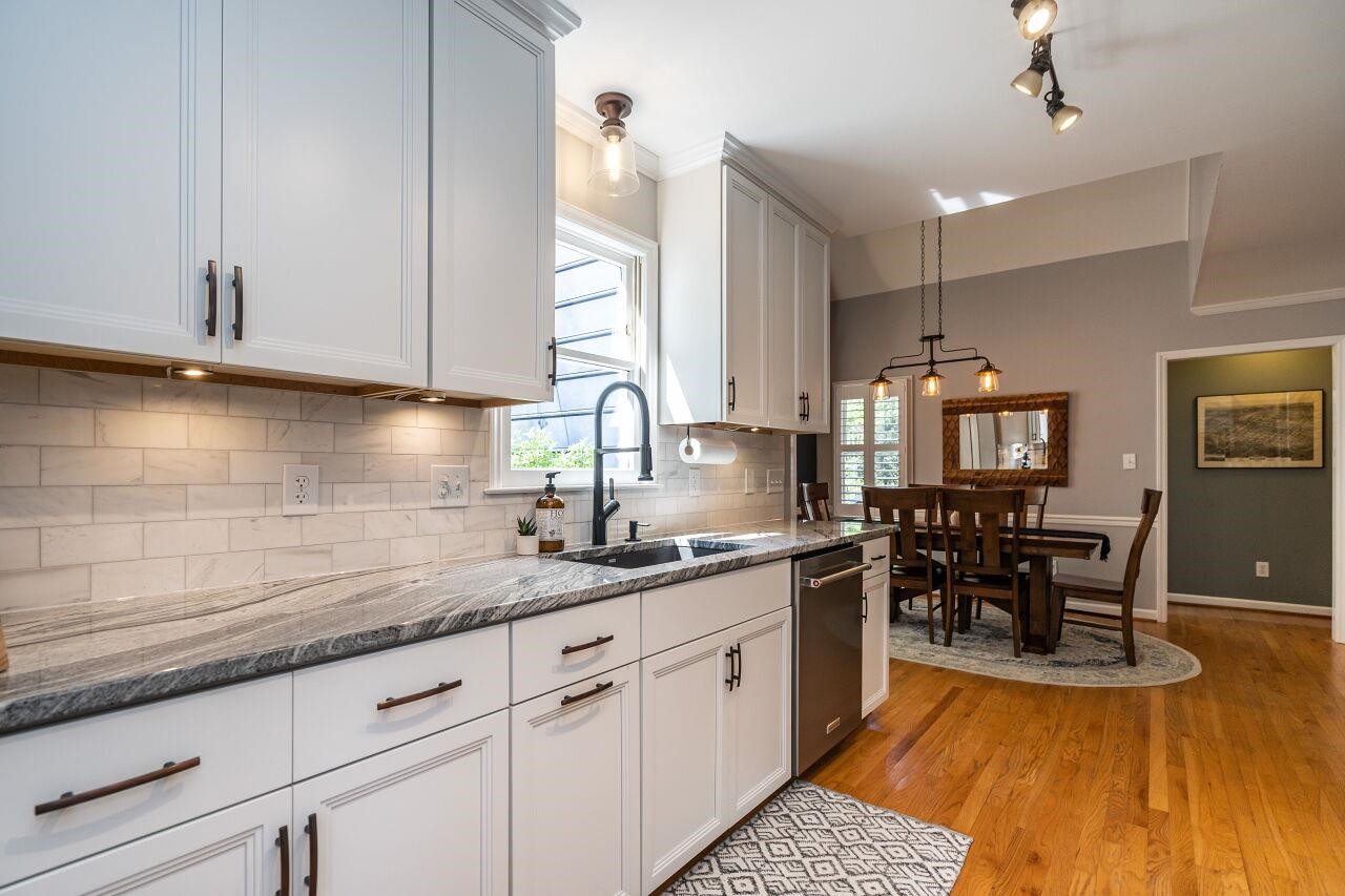 5905 Stable Court Raleigh, NC 27612 - Photo 11 of 30 a kitchen with sink cabinets and dining table