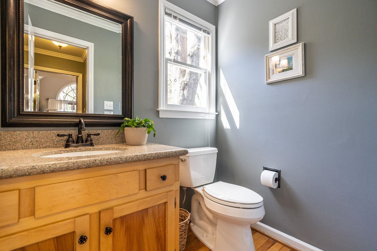 5905 Stable Court Raleigh, NC 27612 - Photo 14 of 30 a bathroom with a granite countertop toilet sink and mirror