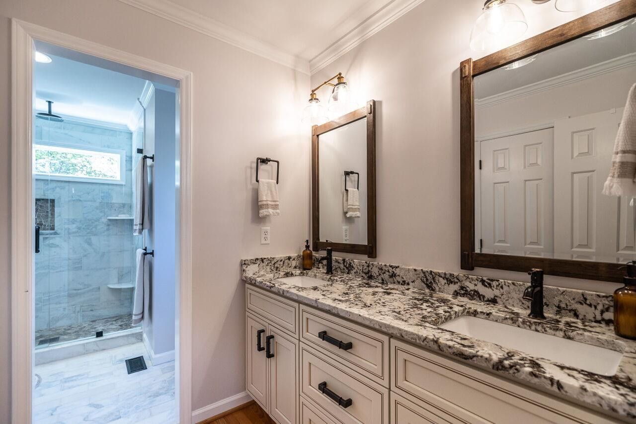 5905 Stable Court Raleigh, NC 27612 - Photo 18 of 30 a bathroom with a sink and a mirror
