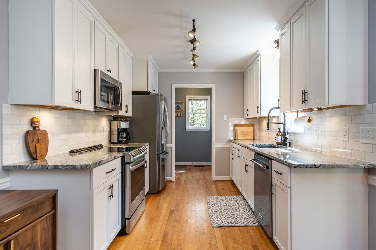 5905 Stable Court Raleigh, NC 27612 - Photo 8 of 30 a kitchen with stainless steel appliances granite countertop a sink stove and refrigerator