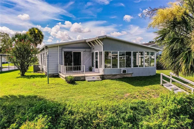 a large kitchen with stainless steel appliances granite countertop a lot of counter space and a wooden floor