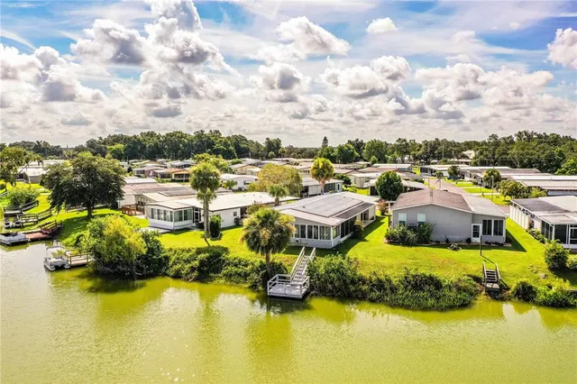 a kitchen with stainless steel appliances granite countertop a refrigerator a sink dishwasher a stove and a microwave oven