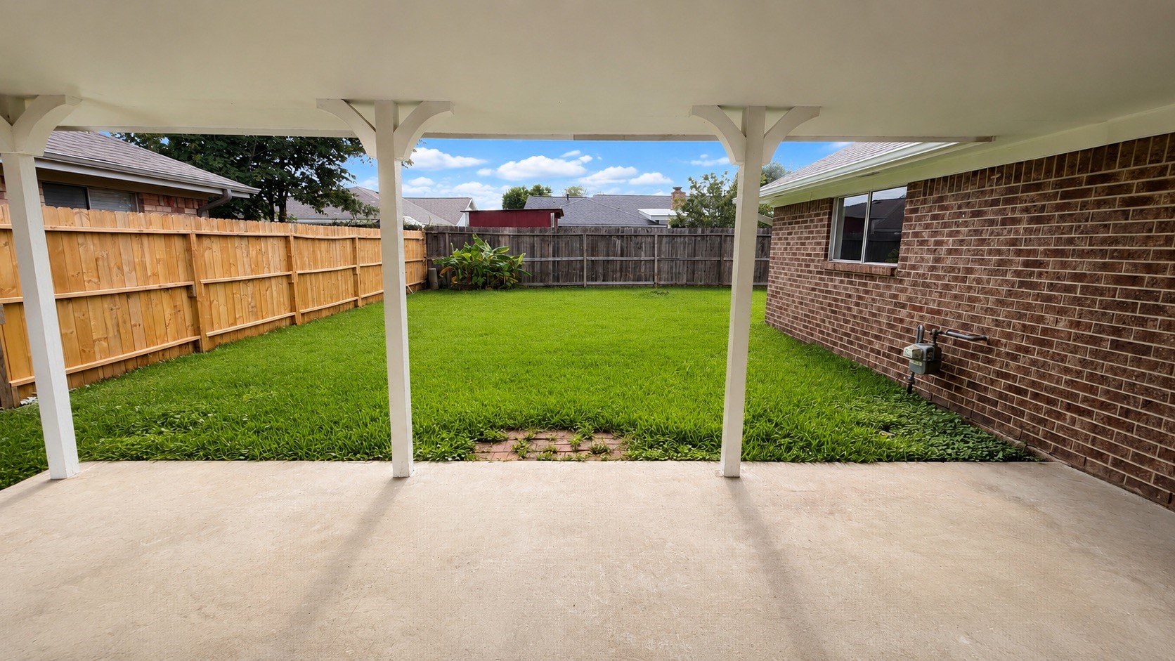 4418 Ponca Street Pasadena, TX 77504 - Photo 20 of 23 Patio view back to the fenced yard with room to keep things simple outside. (image has been enhance for marketing purposes)