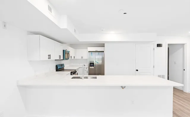a bathroom with a sink vanity and mirror