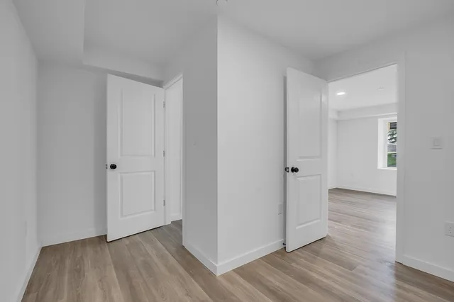 a view of an empty room and wooden floor