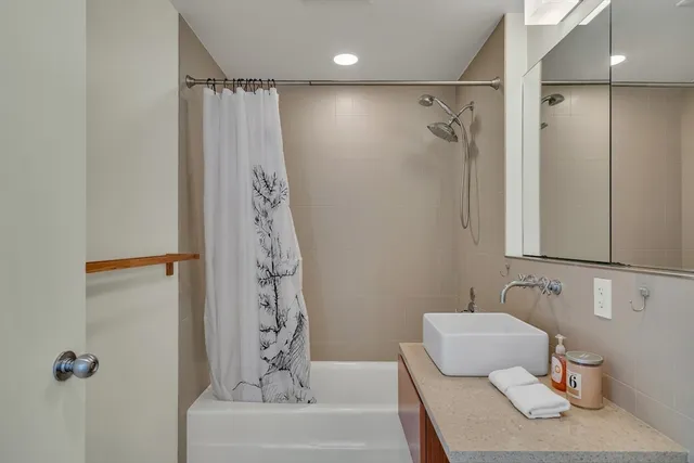 a bathroom with a shower curtain and a sink