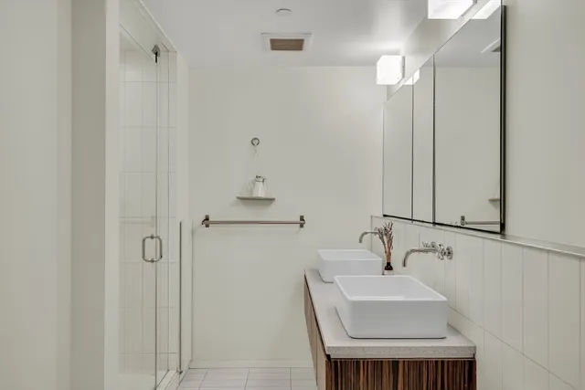 a bathroom with a sink a toilet and a mirror