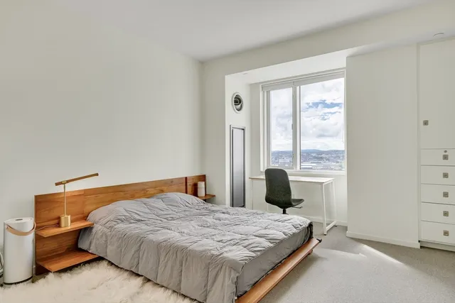 a bedroom with a bed and window