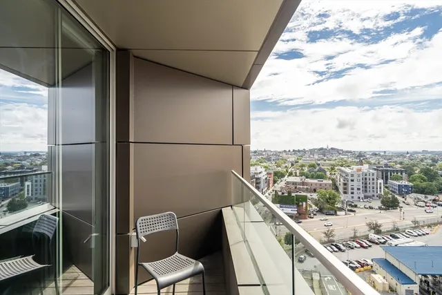 a view of a balcony with chair and refrigerator