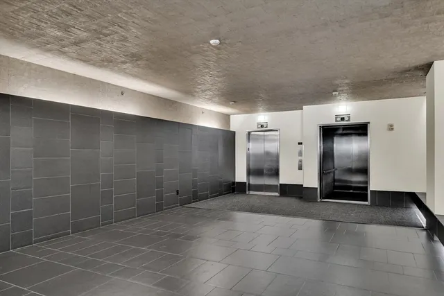 a view of a hallway with stainless steel appliances