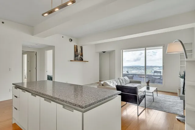 a kitchen with granite countertop a table chairs stove and granite counter tops