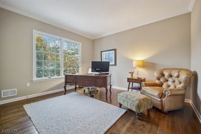 a bedroom with furniture and wooden floor