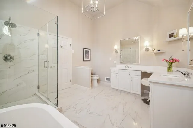 a view of walk in closet with clothes