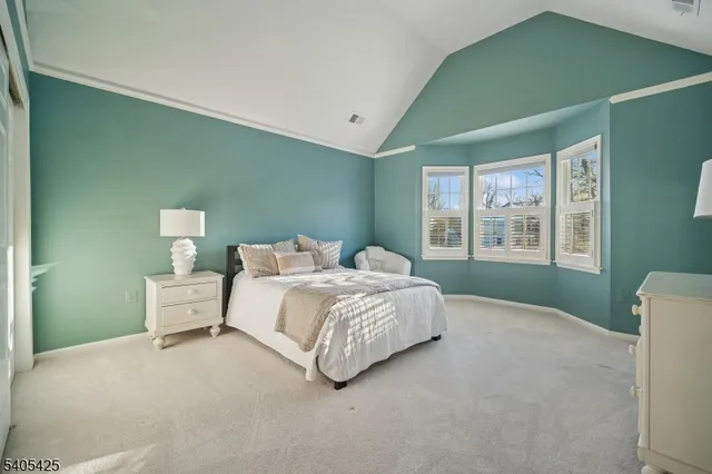 a spacious bedroom with a bed and a couch