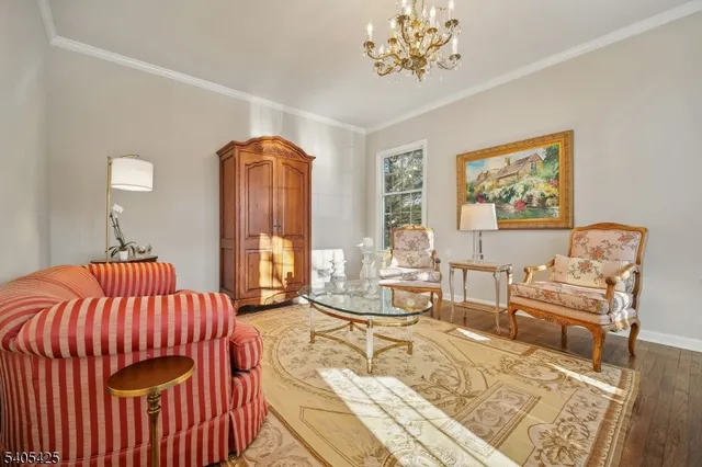 a dining room with furniture a chandelier and wooden floor