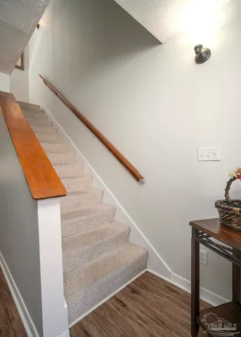 a view of entryway and hall with wooden floor