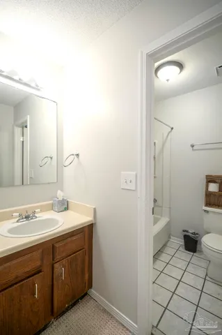 a spacious bathroom with a sink a toilet and a mirror