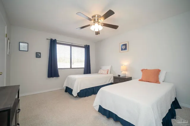 a bedroom with two beds and a chandelier