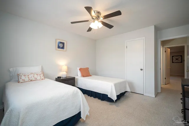 a bedroom with two beds and a chandelier