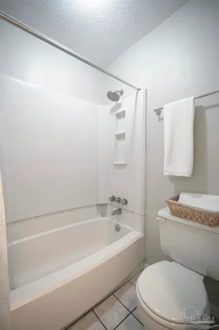 a bathroom with a toilet and a bathtub