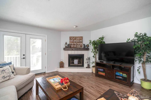 a living room with furniture a fireplace and a flat screen tv