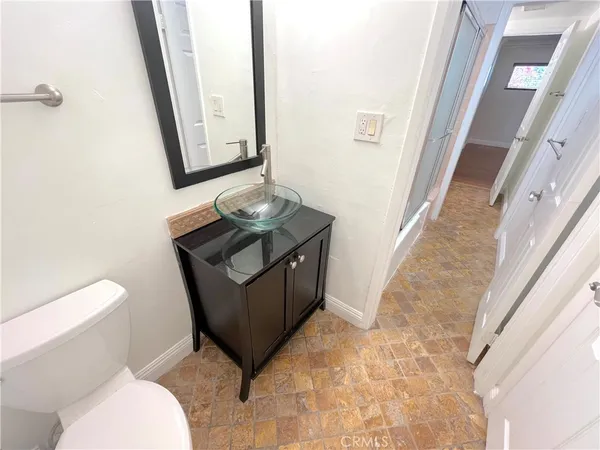 a bathroom with a sink a toilet and mirror