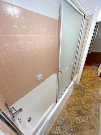 a bathroom with a tub and shower
