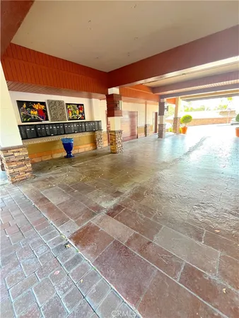 a view of a porch with wooden floor and a yard