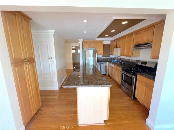 a kitchen with stainless steel appliances granite countertop a sink and a stove top oven