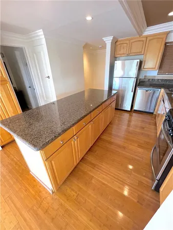 a view of a kitchen with kitchen island and a stove