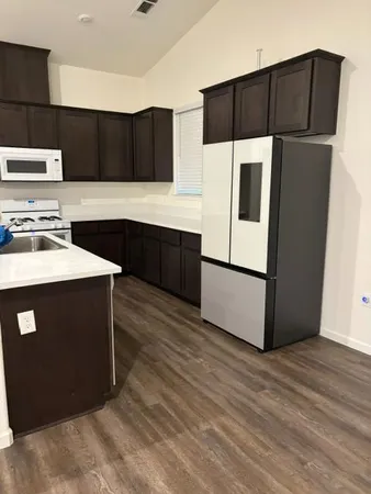 a kitchen with stainless steel appliances a refrigerator stove and microwave