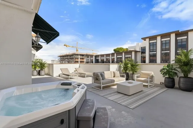 a view of a patio with couches and potted plants