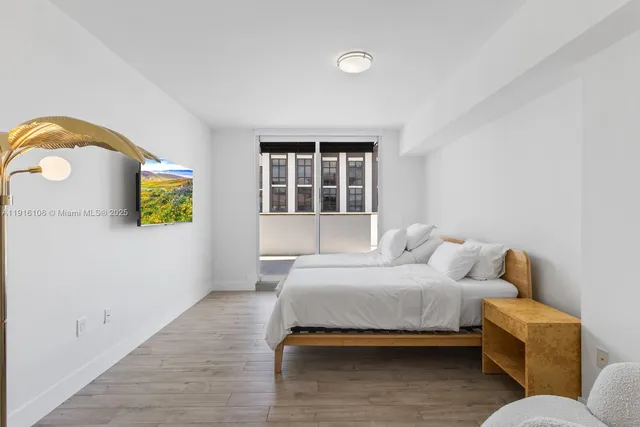 a bedroom with a bed and a window