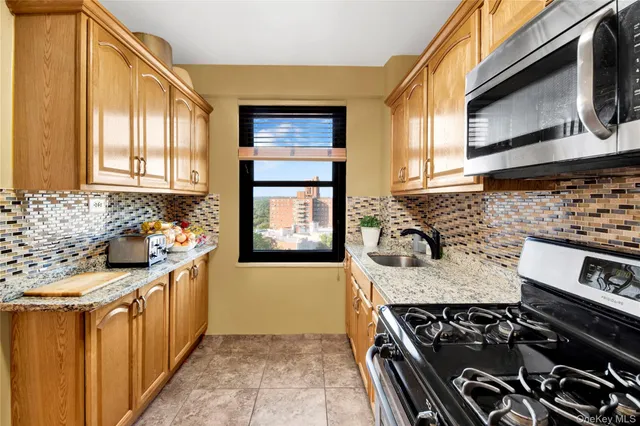 a kitchen with stainless steel appliances granite countertop a stove and a sink