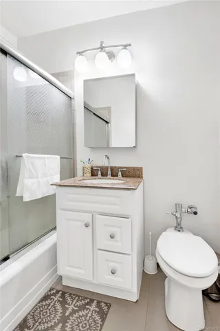 a bathroom with a sink a toilet and bathtub