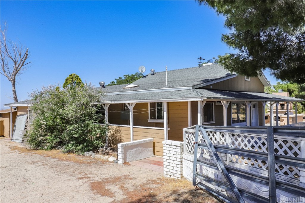 21123 Fort Tejon Road Llano, CA 93544 - Photo 29 of 55 a view of a house with wooden deck and furniture